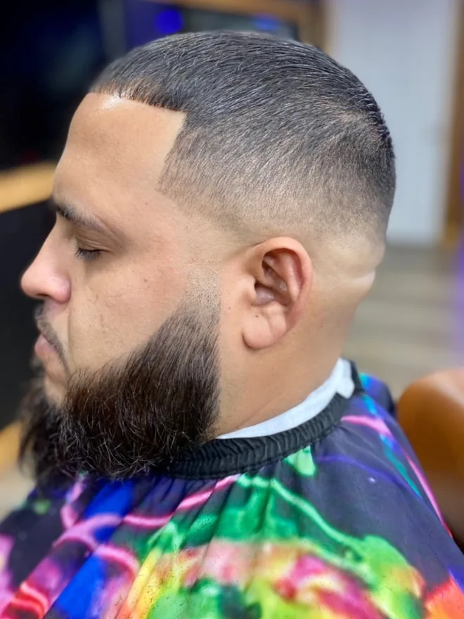 Full beard with a crisp skin fade